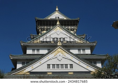 Osaka, Japan - November 22, 2023: Osaka Castle one of the most famous landmarks in Japan with traditional architecture. White dominate with green rooftile, with blue sky backround during the autumn.