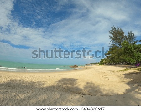 View of the beach with clean white sand and bright blue sky.  Photo taken during the day