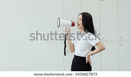 Happy young asian woman using a megaphone on white background, Advertising and public relations announcements concept.