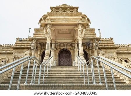 Exterior view of The Shree Sanatan Hindu Mandir Hindu Temple. Elaborately carved Jaisalmer limestone of the entrance to the Shri Sanatan Hindu Temple, Copy space, Selective focus. Royalty-Free Stock Photo #2434830045
