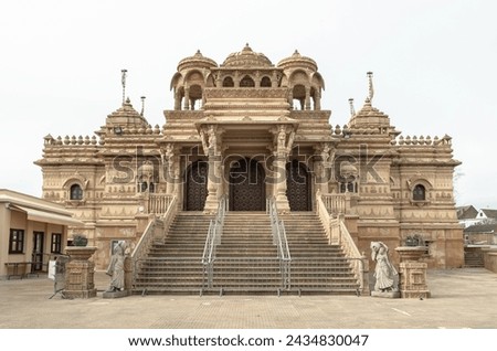 Exterior view of The Shree Sanatan Hindu Mandir Hindu Temple. Elaborately carved Jaisalmer limestone of the entrance to the Shri Sanatan Hindu Temple, Space for text, Selective focus. Royalty-Free Stock Photo #2434830047