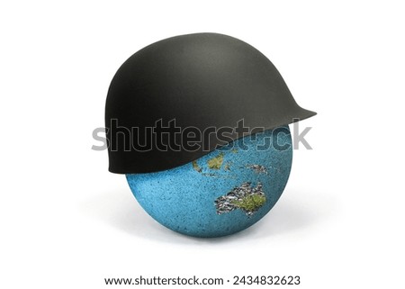 Earth Globe covered with a soldier's helmet showing Africa and Australia: war concept. The soldier's helmet symbolizes war and war conflicts that lead to death and destruction. Royalty-Free Stock Photo #2434832623