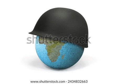 Earth Globe covered with a soldier's helmet where you can see Africa and America: war concept. The soldier's helmet symbolizes war and war conflicts that lead to death and destruction. Royalty-Free Stock Photo #2434832663