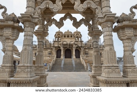 Entrance archway of The Shree Sanatan Hindu Mandir Hindu Temple (The Shri Sanatan Hindu Temple). Gates of Neasden Temple build from Elaborately carved Jaisalmer limestone, Space for text, Selective fo Royalty-Free Stock Photo #2434833385