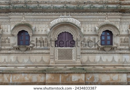 Architecture exterior and Windows of The Shree Sanatan Hindu Mandir Hindu Temple (The Shri Sanatan Hindu Temple) build from Elaborately carved Jaisalmer limestone, Space for text, Selective focus. Royalty-Free Stock Photo #2434833387
