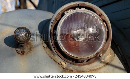 The headlight of an old Soviet car. Car detail. close-up Royalty-Free Stock Photo #2434834093