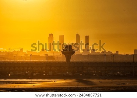 Sunset in the airport or Madrid Adolfo Suarez with de Five Towers of Madrid and the Control Tower of the airport in the midle ot them Royalty-Free Stock Photo #2434837721