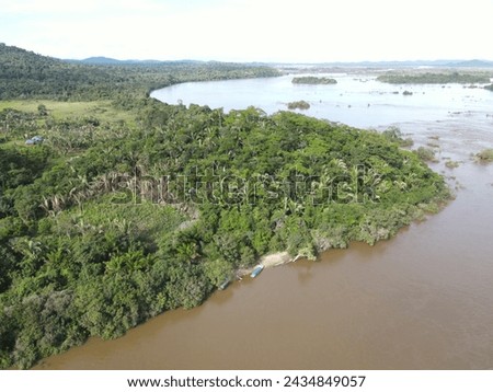 Aerial view of the indigenous land of Koatinemo, a demarcated area where the Assurini people live, on the banks of the Xingu River, State of Pará. Amazon Forest. Altamira city. Protected forest Royalty-Free Stock Photo #2434849057