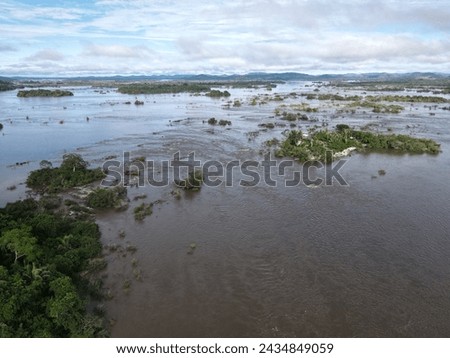 Aerial view of the indigenous land of Koatinemo, a demarcated area where the Assurini people live, on the banks of the Xingu River, State of Pará. Amazon Forest. Altamira city. Protected forest Royalty-Free Stock Photo #2434849059