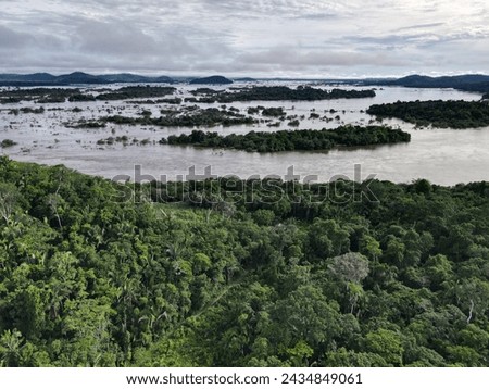 Aerial view of the indigenous land of Koatinemo, a demarcated area where the Assurini people live, on the banks of the Xingu River, State of Pará. Amazon Forest. Altamira city. Protected forest Royalty-Free Stock Photo #2434849061