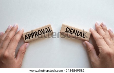 Approval or Denial symbol. Concept word Approval or Denial on wooden blocks. Businessman hand. Beautiful white background. Business and Approval or Denial concept. Copy space Royalty-Free Stock Photo #2434849583