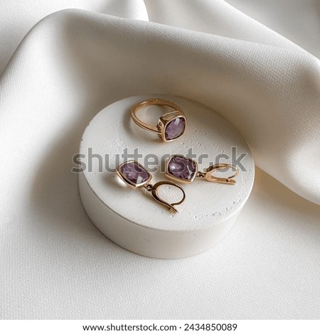 Stylish modern gold set ring earrings with purple amethyst. 