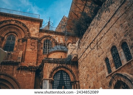 Church of the Holy Sepulcher in the Old City of Jerusalem, Israel. Typical stoned houses and walls of jewish historic quarter area part. Royalty-Free Stock Photo #2434852089