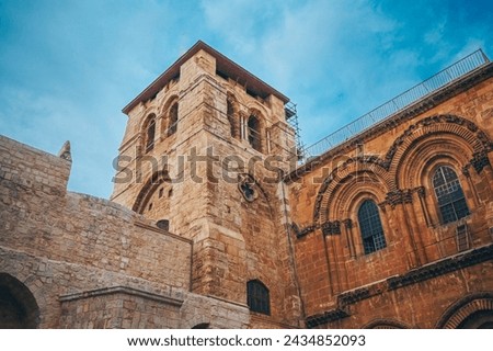 Church of the Holy Sepulcher in the Old City of Jerusalem, Israel. Typical stoned houses and walls of jewish historic quarter area part. Royalty-Free Stock Photo #2434852093