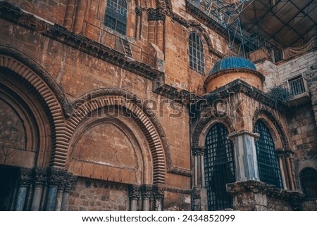Church of the Holy Sepulcher in the Old City of Jerusalem, Israel. Typical stoned houses and walls of jewish historic quarter area part. Royalty-Free Stock Photo #2434852099