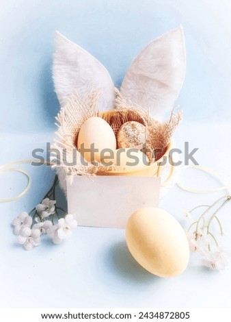 
 colorful eggs in yellow nest and  blue background