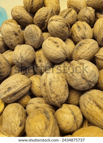 Harvesting Nature's Bounty: Fresh and Nutty Walnuts , Nutty Delights: Fresh Harvest of Walnuts Royalty-Free Stock Photo #2434875737