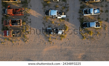 a photo from a drone of a site with wrecked cars and sunsets, selling wrecked cars of various brands and colors