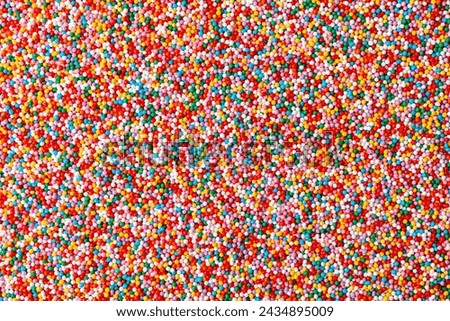 Confectionery sprinkles. Colorful background texture. Decoration for cake and bakery. Top view Royalty-Free Stock Photo #2434895009