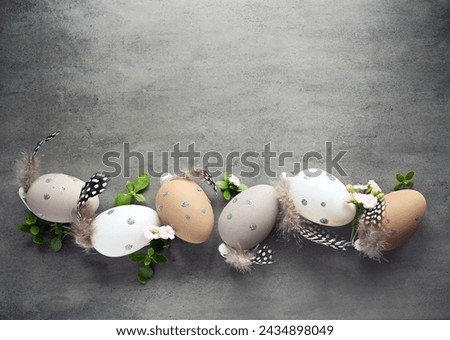Collection of stylish colors eggs with flowers for Easter celebration on grey background. Holiday concept.