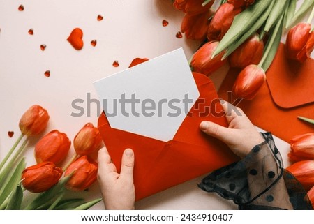 Girl holding an empty envelope with space for text, concept Happy Mother's Day, Happy Valentine's Day.