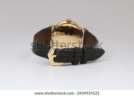 Gold watch with a black leather strap