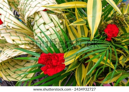 Traditional Ecuadorian decorative Palm Sunday bouquets made from palm leaves and carnations are sold at the Flower Market in Cuenca. Royalty-Free Stock Photo #2434932727