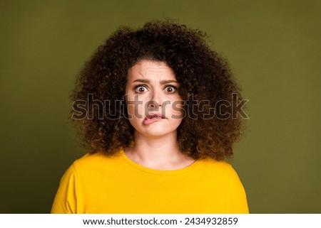 Close up photo of staring young woman in yellow shirt biting lips afraid panic watching russian invasion isolated on khaki color background Royalty-Free Stock Photo #2434932859