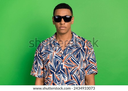 Photo of serious confident guy nice man wearing stylish print clothes isolated on green color background