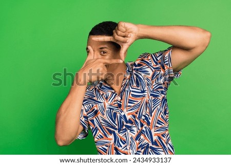 Photo of positive young man wear stylish clothes look camera make video film picture isolated on green color background