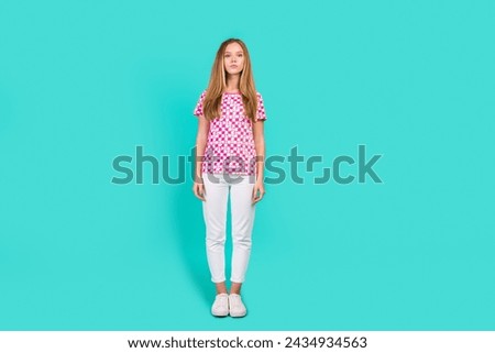 Full length photo of lovely teen lady stand model dressed stylish pink print garment isolated on aquamarine color background