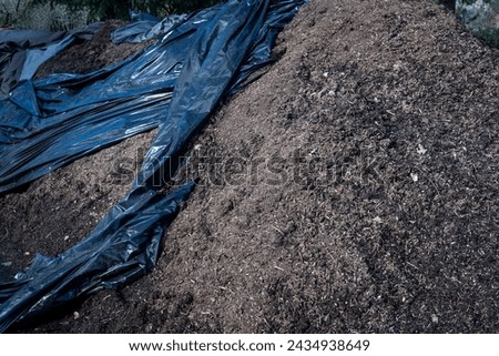 Large pile of rich mulch ready for spring gardening, outdoor public park on a sunny day
 Royalty-Free Stock Photo #2434938649