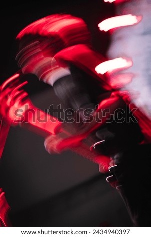 Picture of the bassist of a band  Set the camera using a low shutter speed and crank the camera.  This gives the effect of a soul leaving the body.