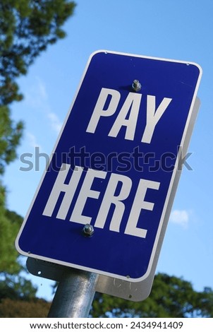 Pay here sign, sign at a parking meter in Brisbane, Queensland, Australia