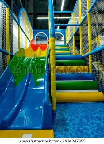 indoor playground with colorful slides and stairs
