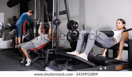 Multiple people using fitness machines in gym Royalty-Free Stock Photo #2434952809