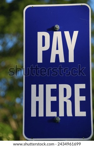 Pay here sign, sign at a parking meter in Brisbane, Queensland, Australia