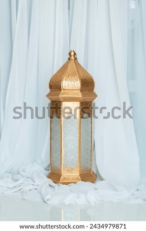 Moroccan lantern isolated on white curtain background, Islamic festival concept image Royalty-Free Stock Photo #2434979871