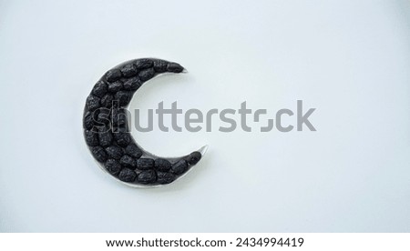 Iftar food background, Dates in a crescent moon shaped plate isolated on white background with copy space for text