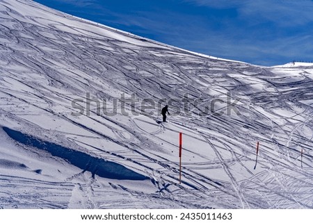 Silhouette of male snowboarder way down from off piste part to slope at Swiss ski resort Stoos on a sunny winter day. Photo taken February 13th, 2024, Stoos, Klingenstock, Switzerland. Royalty-Free Stock Photo #2435011463