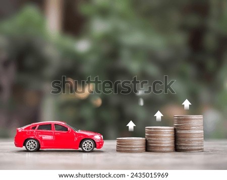 Toy car, stack of coins with arrow rising. The concept of business growth, saving money and manage to success transport business