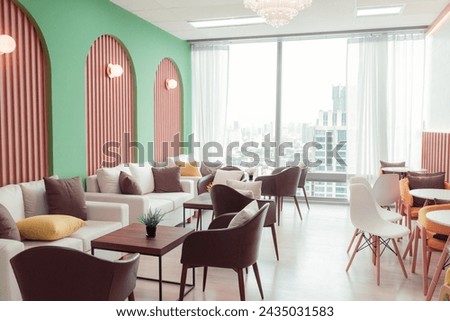 Empty stylish and modern office interior with skyscrapers view decorated with table, chair, botany decoration, elegant accessory. Living room. Modern interior. Creative design. Day light. Ornamented. Royalty-Free Stock Photo #2435031583