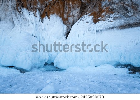 Coast of lake Baikal in winter, the deepest and largest freshwater lake by volume in the world, located in southern Siberia, Russia Royalty-Free Stock Photo #2435038073