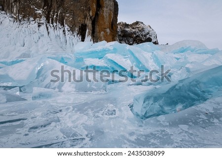 Coast of lake Baikal in winter, the deepest and largest freshwater lake by volume in the world, located in southern Siberia, Russia Royalty-Free Stock Photo #2435038099