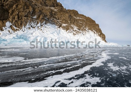 Coast of lake Baikal in winter, the deepest and largest freshwater lake by volume in the world, located in southern Siberia, Russia Royalty-Free Stock Photo #2435038121