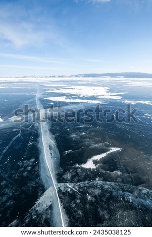 Ice of Lake Baikal, the deepest and largest freshwater lake by volume in the world, located in southern Siberia, Russia Royalty-Free Stock Photo #2435038125