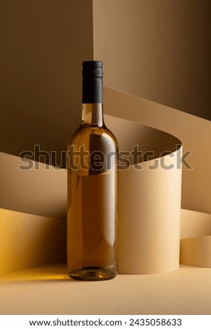 Bottle of white wine on a beige background. Copy space.