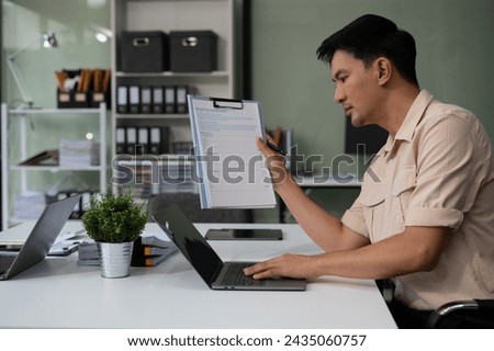 Business man sitting at his desk in the office.