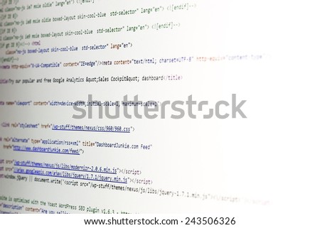 Close-up of HTML code on computer monitor. Black and colored text on white background.