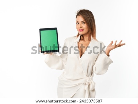 enterprising Latina woman demonstrates green screen digital tablet for commercial use